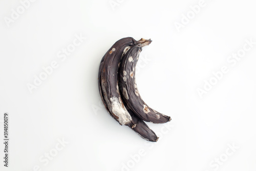 Quadro em tela Spoiled moldy bananas on white background