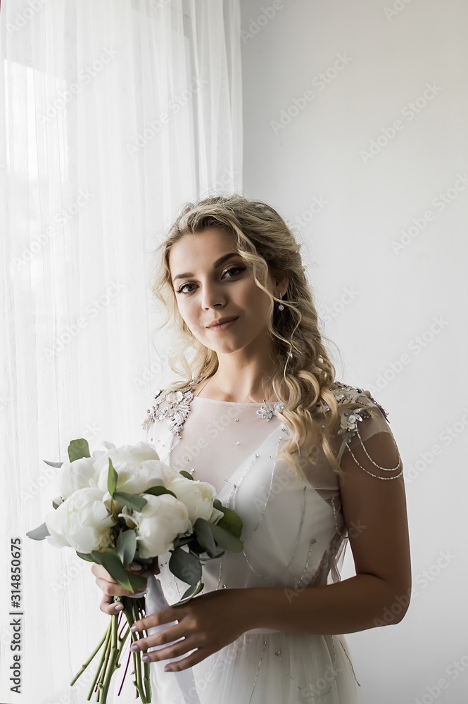 bride with a bouquet in her hands on the wedding day. wedding ceremony. selective focus. film grain.