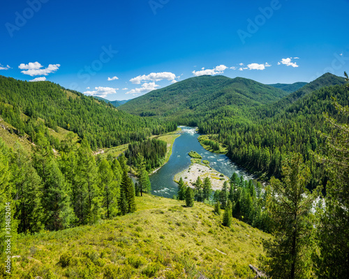 Summer siberian mountain landscape. Balyiktyig hem river and Sayan mountains covered by taiga forest in sunny day. photo