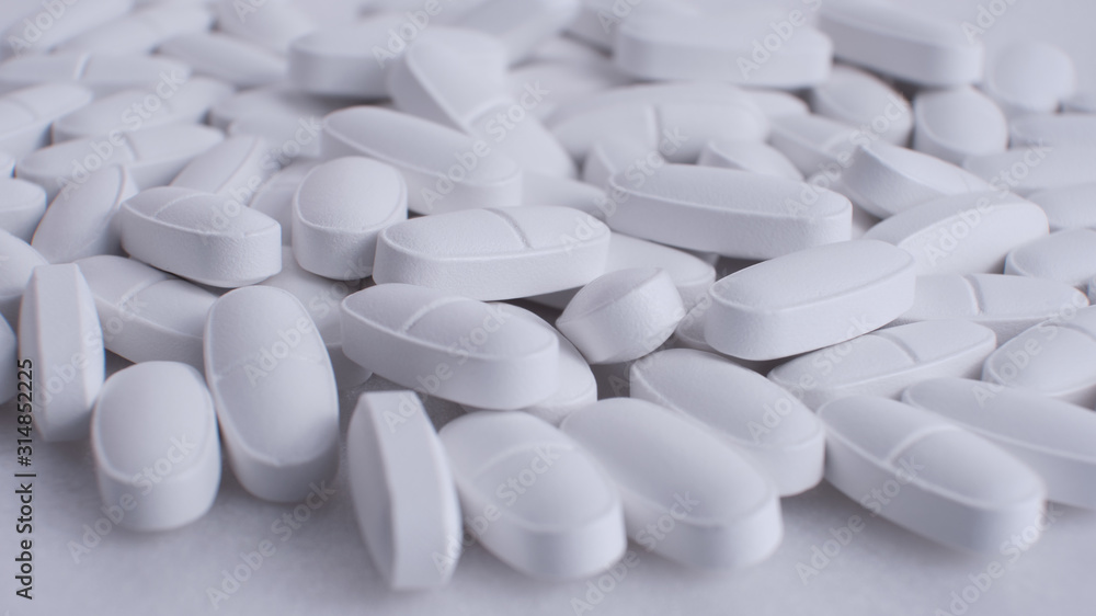 white tablets pattern, multivitamins in tablets , closeup white pills scattered on the table, panoramic banner