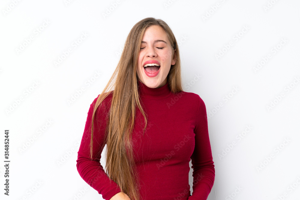 Teenager blonde girl over isolated white background shouting to the front with mouth wide open Teenager blonde girl over isolated white background shouting to the front with mouth wide open