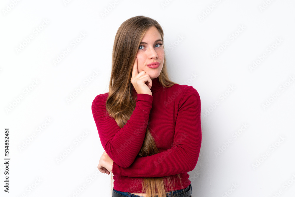 Teenager blonde girl over isolated white background Looking front Teenager blonde girl over isolated white background Looking front