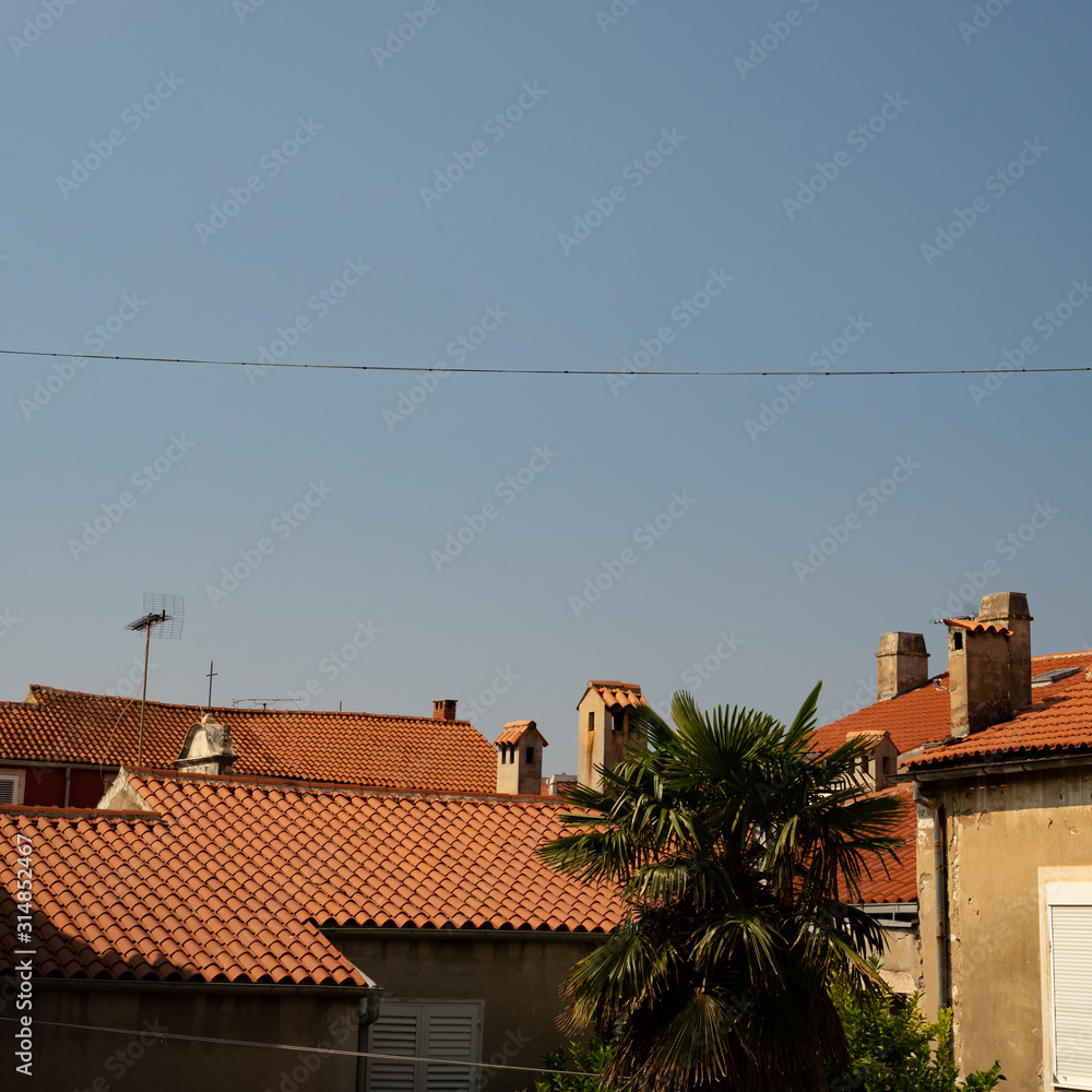 Tile roof tops in Zadar Chroatia against blue sky / rooftops Tile roof tops in Zadar Chroatia against blue sky / rooftops