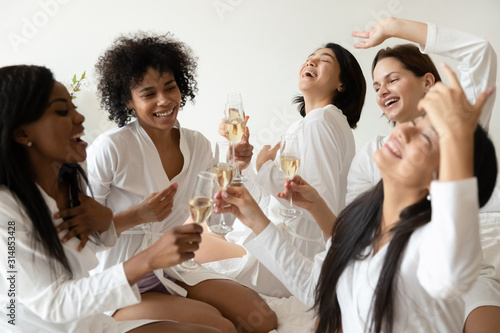 Photography Overjoyed diverse girls celebrate hen party drinking wine