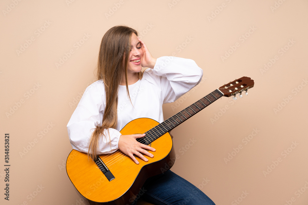 Teenager girl with guitar over isolated background has realized something and intending the solution Teenager girl with guitar over isolated background has realized something and intending the solution