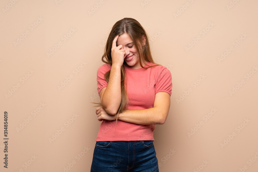 Teenager blonde girl over isolated background laughing Teenager blonde girl over isolated background laughing