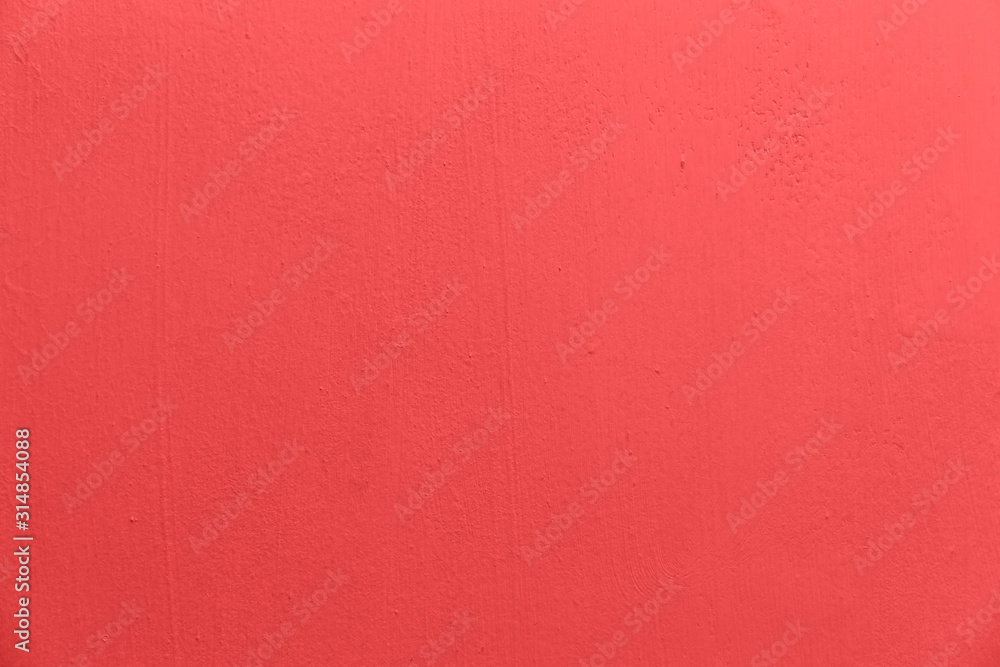 Fototapeta premium concrete wall with an uneven texture is painted pink