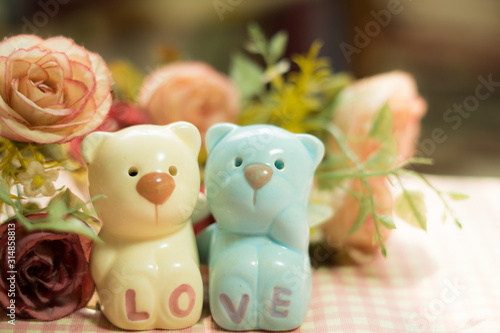 Ceramic Statues Little bear lovers with flower decoration blur background. Valentine Concept.Vintage and Instragram style © Walaiporn Paysawat