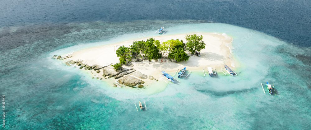 View from above, stunning aerial view of Gili Kedis with a beautiful white sand beach bathed by a turquoise and crystal clear water. Gili Kedis is a small island in southern Lombok, Indonesia.