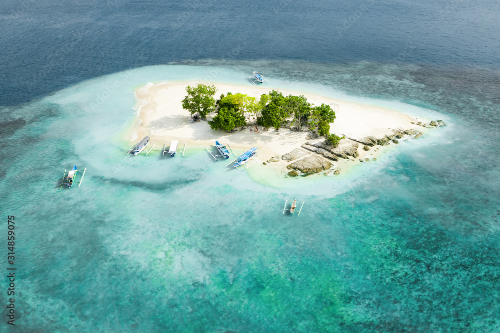 View from above, stunning aerial view of Gili Kedis with a beautiful white sand beach bathed by a turquoise and crystal clear water. Gili Kedis is a small island in southern Lombok, Indonesia.