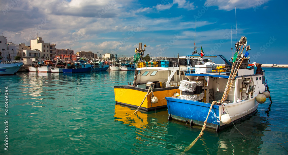 Fishing boats at the old port of Porto Vecchio in Monopoli Puglia Italy - obrazy, fototapety, plakaty 
