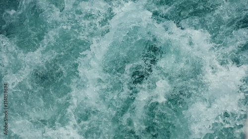 speed tourist motorboat sails in emerald sea making white foamy trace waves close view
