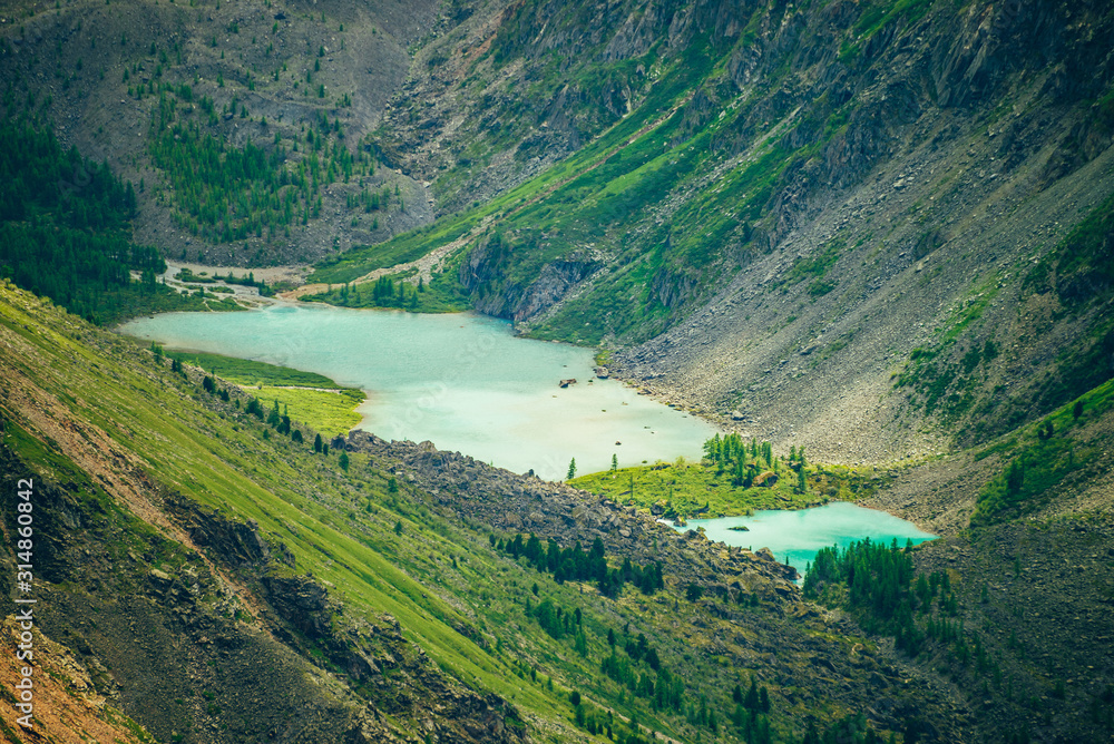 Naklejka premium Aerial spectacular view to scenic valley with two beautiful mountain lakes, conifer forest and rocky mountains. Amazing atmospheric highland landscape. Wonderful majestic wilderness nature scenery.