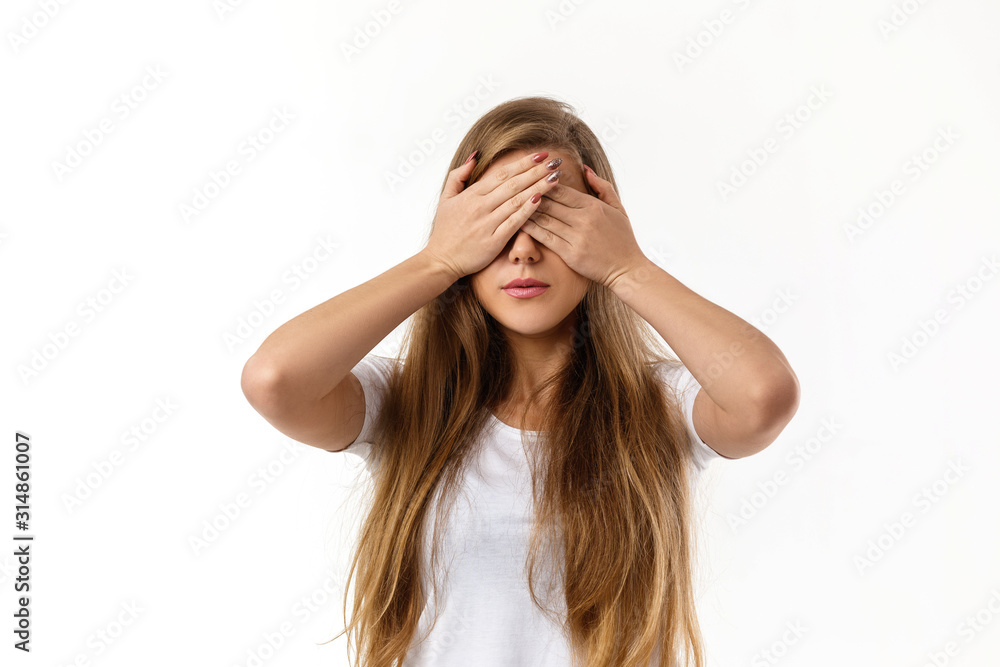 Portrait of young beautiful woman closes her eyes with hand on white background Portrait of young beautiful woman closes her eyes with hand on white background