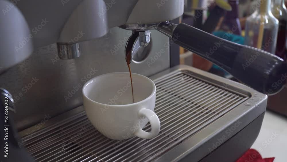 Barista make a espresso coffee having coffee pouring to cup in cafe shop. coffee machine. footage b-roll video scene. Barista make a espresso coffee having coffee pouring to cup in cafe shop. coffee machine. footage b-roll video scene.