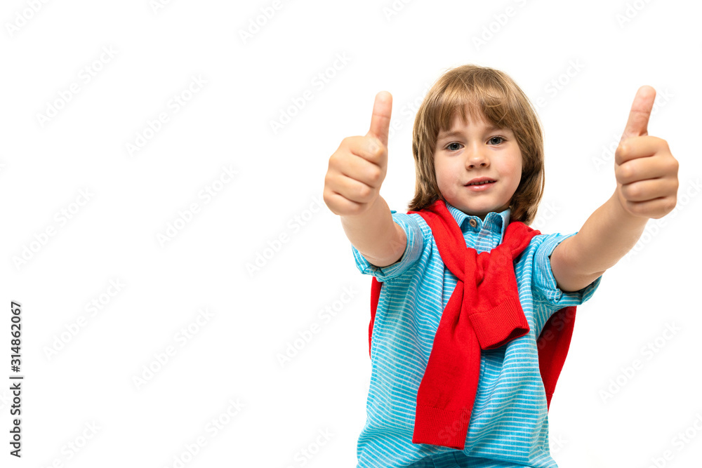 Sports teenager boy in t-shirt with hoody around his neck gesticulates isolated on blue background Sports teenager boy in t-shirt with hoody around his neck gesticulates isolated on blue background