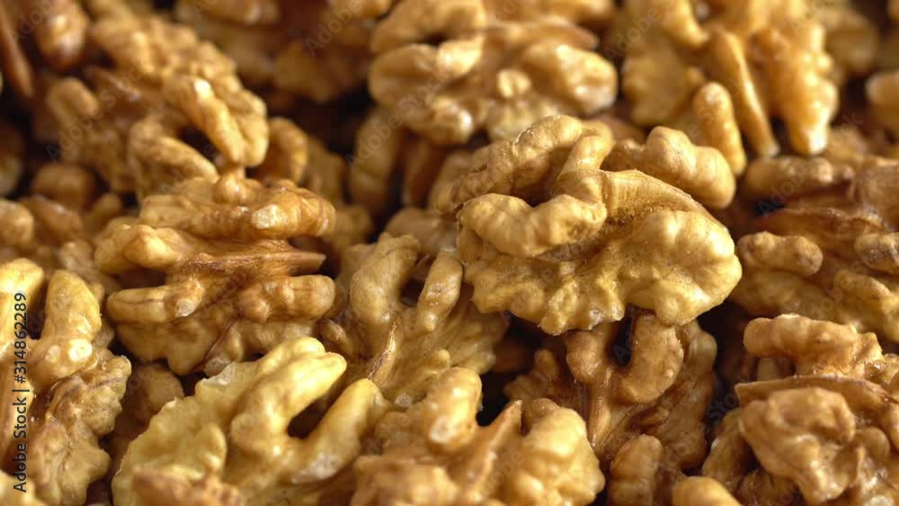Walnut close up. product rich in minerals and vitamins. Walnut turns in a shot. Walnut kernels rotating. walnut close up lies under beams of the sun. Macro Walnut close up. product rich in minerals and vitamins. Walnut turns in a shot. Walnut kernels rotating. walnut close up lies under beams of the sun. Macro