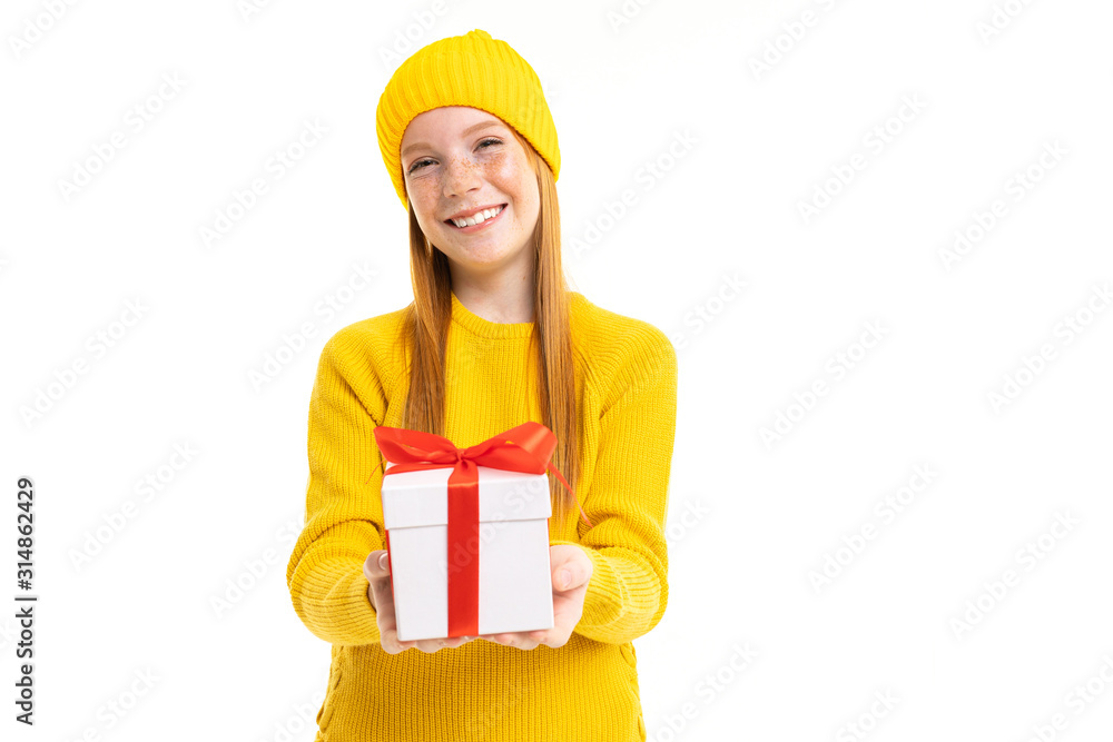 portrait of a happy red-haired girl with a box tied with a ribbon on a white background with copy space portrait of a happy red-haired girl with a box tied with a ribbon on a white background with copy space