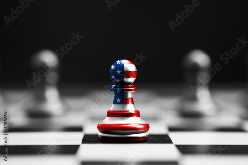 USA flag print screen on pawn chess with black background. United States of America is leader of economy and military in the world.
