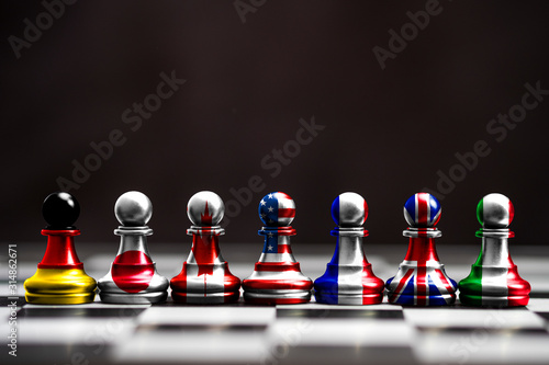 Flag of G7 countries print screen on pawn chess with black background. G7 are includes USA Germany Japan Canada France England and Italy. photo