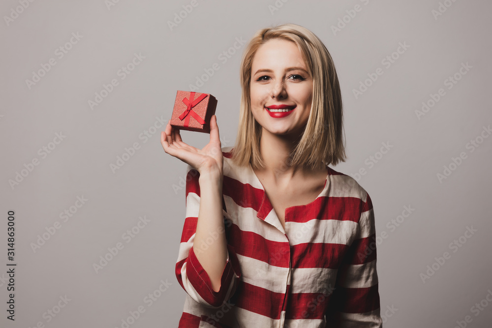 girl holds gift box on gray background girl holds gift box on gray background