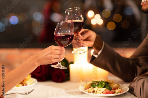 Couple s Hands Clinking Glasses Of Red Wine Dating In Restaurant