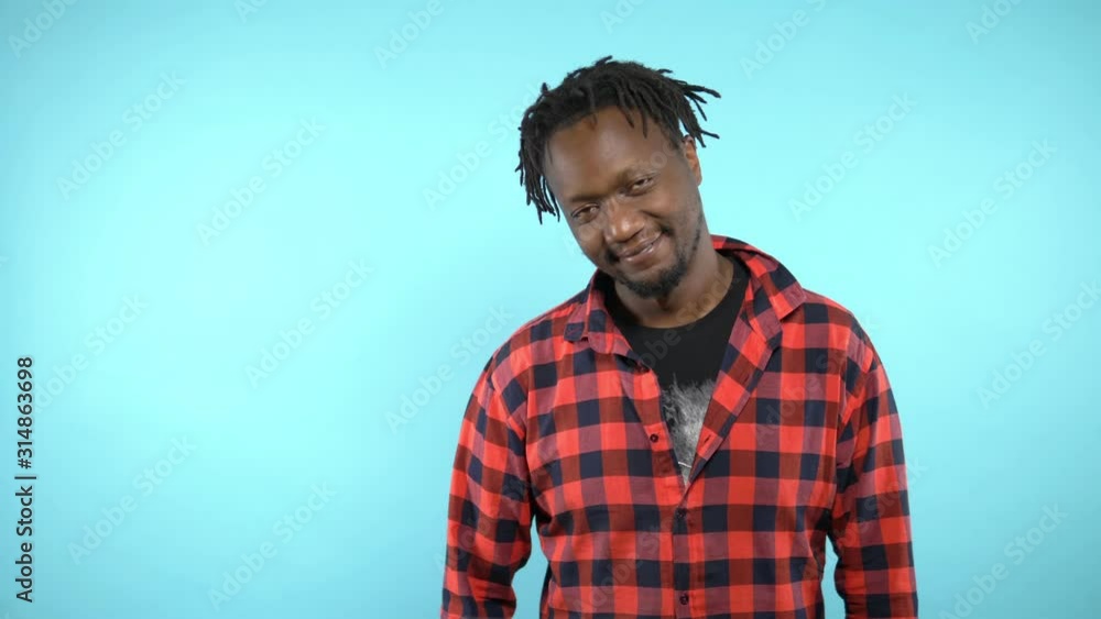 portrait of a stylish handsome African guy on blue background portrait of a stylish handsome African guy on blue background