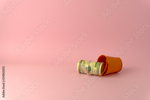 100 USD roll inside small bucket isolate on pink color background space use as online shopping business concept