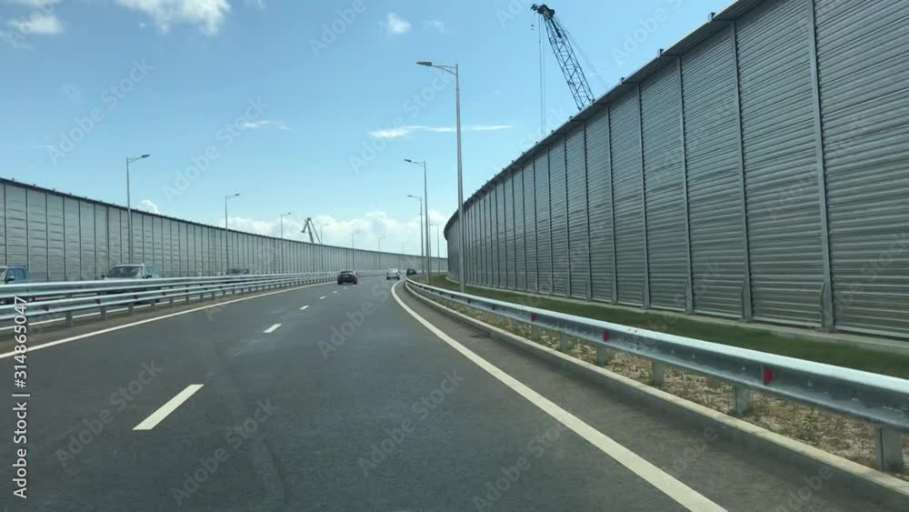 Kerch, Crimea, Ukraine - September 2018: Travel along the Crimean bridge from Ukraine to Russia. The route through the Kerch bridge. New bridge in the occupied Crimea. Cars ride on the Kerch bridge. Kerch, Crimea, Ukraine - September 2018: Travel along the Crimean bridge from Ukraine to Russia. The route through the Kerch bridge. New bridge in the occupied Crimea. Cars ride on the Kerch bridge.