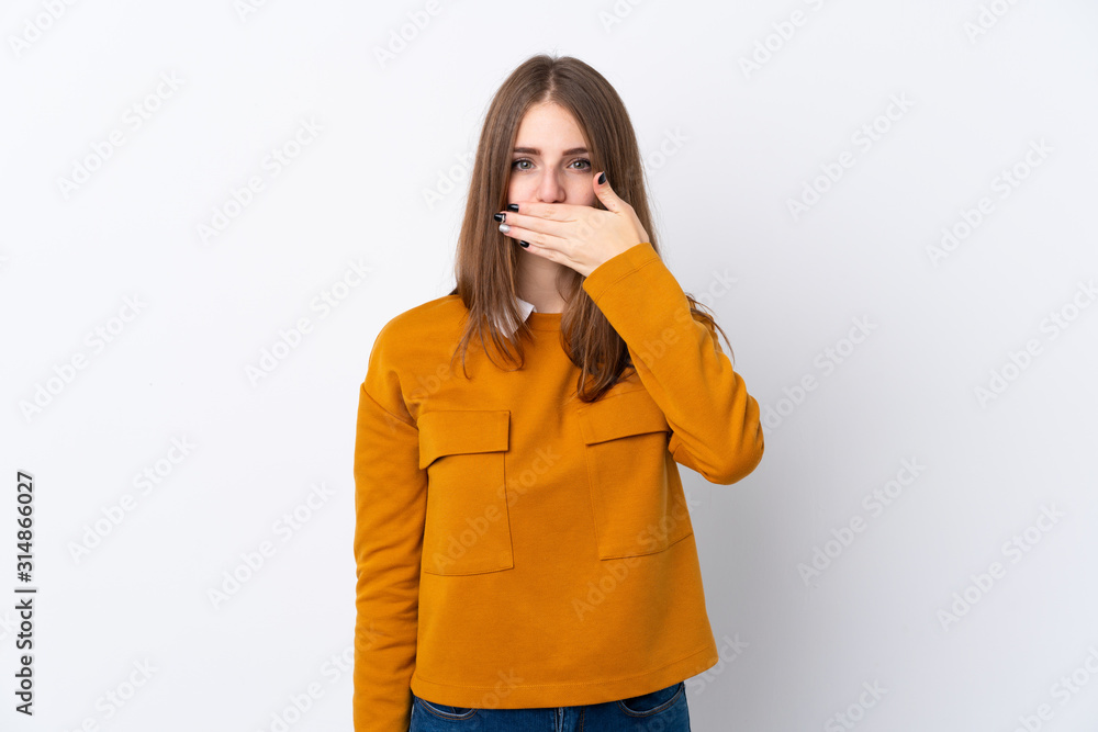 Young woman over isolated white background covering mouth with hands Young woman over isolated white background covering mouth with hands
