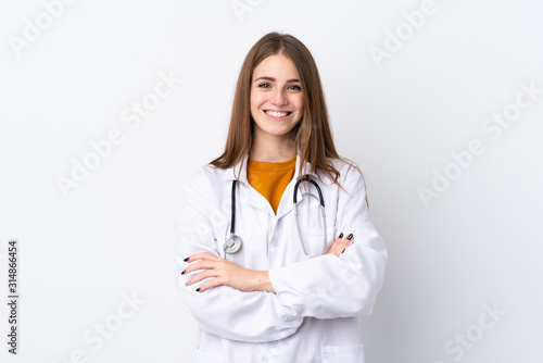 Young woman over isolated background wearing a doctor gown and with arms crossed