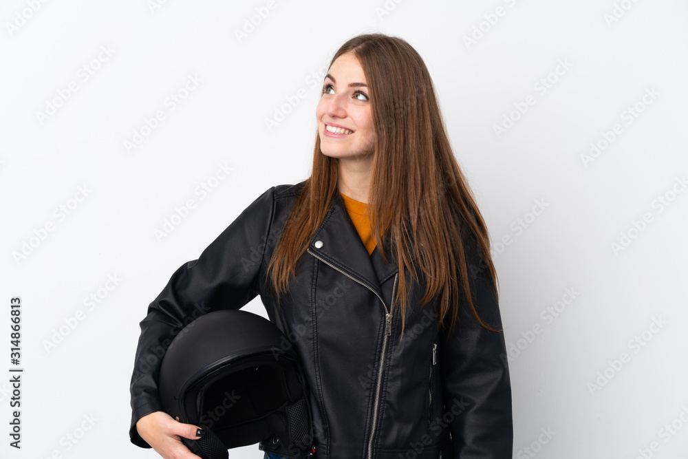 Woman with a motorcycle helmet laughing and looking up Woman with a motorcycle helmet laughing and looking up