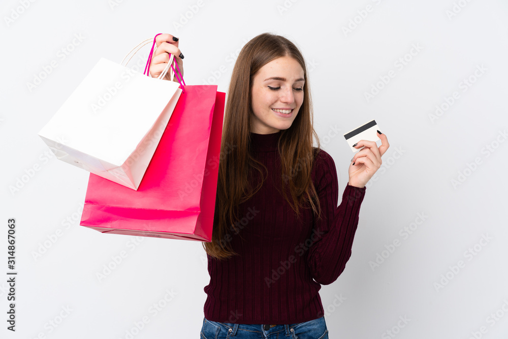 Young woman over isolated white background holding shopping bags and a credit card Young woman over isolated white background holding shopping bags and a credit card