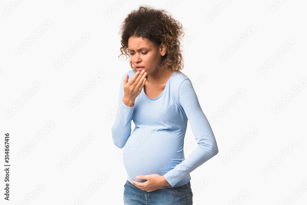 Afro pregnant lady feeling sick, having nausea on white background Afro pregnant lady feeling sick, having nausea on white background