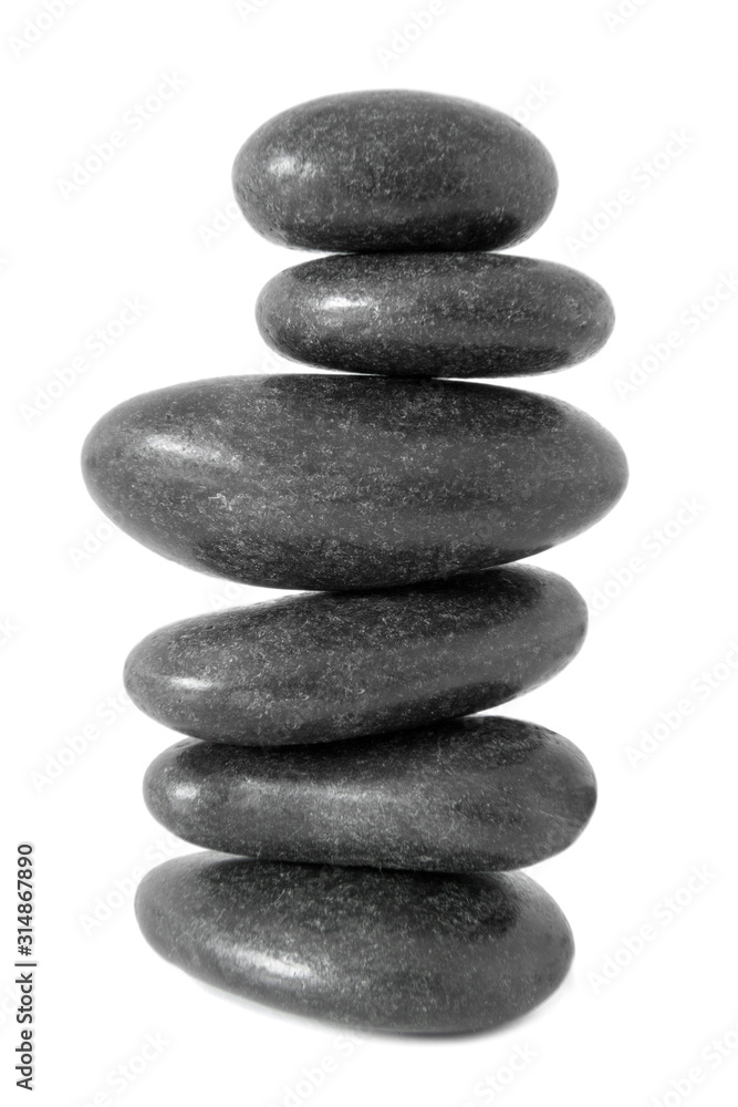 Stacked natural smooth grey stones in zen balance isolated on white background Stacked natural smooth grey stones in zen balance isolated on white background