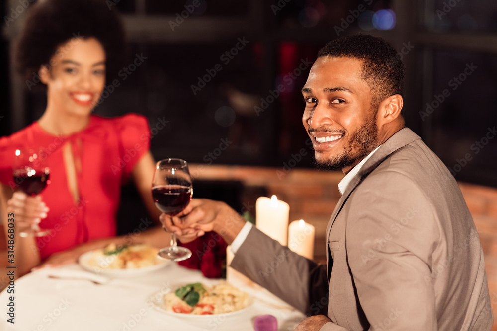 Cheerful Couple Holding Wine Glasses Smiling Celebrating Valentine In Restaurant
