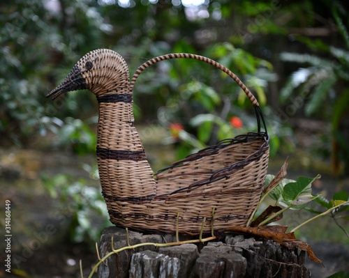 wicker basket in the form of a swan in a tropical garden