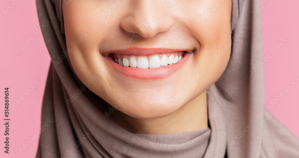 Wide smile with perfect teeth of muslim girl in hijab, closeup Wide smile with perfect teeth of muslim girl in hijab, closeup