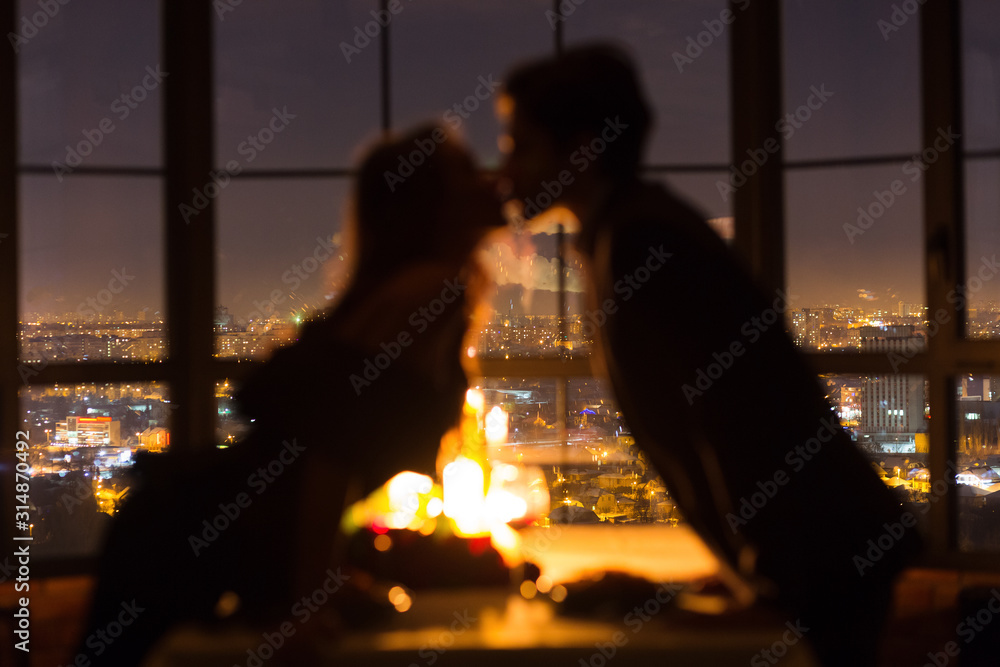 Couple kissing on romantic date, celebrating Valentine's Day