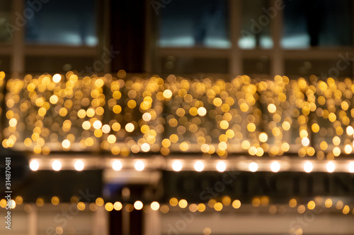 Festlicher Hintergrund mit goldenem Bokeh und sch  ner Unsch  rfe von weihnachtlicher Beleuchtung als leuchtender Hintergrund f  r Einladungskarten und Party-Festlichkeiten