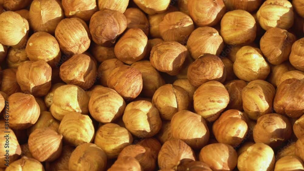 Walnut close up. product rich in minerals and vitamins. Hazelnut turns in a shot. Hazelnut kernels rotating. Hazelnut close up lies under beams of the sun. Macro 4K