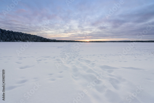 The ice lake has covered with heavy snow and sky in winter season at Oulanka National Park  Finland.