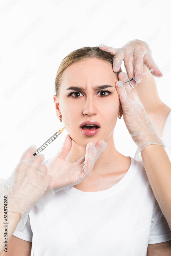 Beautician makes an injection to a beautiful, young girl.