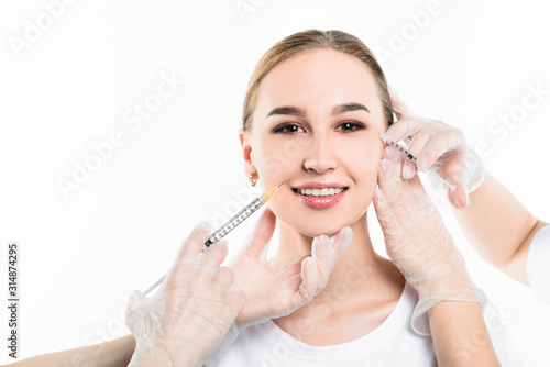 Beautician makes an injection to a beautiful, young girl.