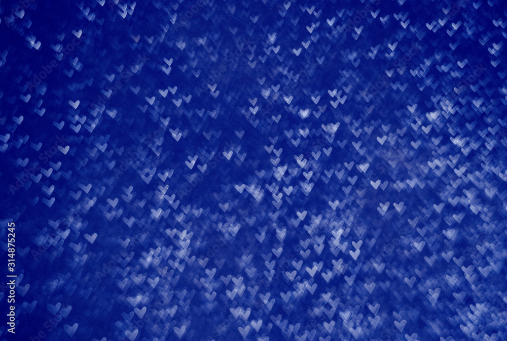 Obraz premium bokeh in the form of blue hearts. Color of the year 2020 classic blue. Main color trend