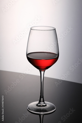 Red Wine Glass on Black Table and White Background