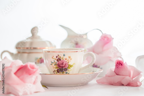 A set of  floral rose pattern fine china porcelain tea set with a tea-pot, sugar pot, creamer, and tea cup