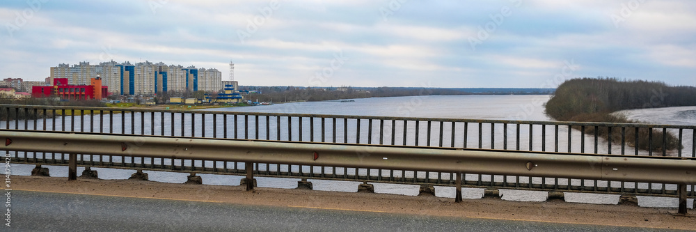 Landscape with the image of the bridge over Volhov river near the town Kirishy in Russia