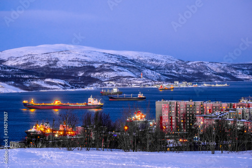 Obraz na płótnie Murmansk, Russia - January, 5, 2020: Non-freezing seaport in the city of Murmansk in winter. The picture was taken at 2 p.m. in natural light at the height of a polar night w salonie