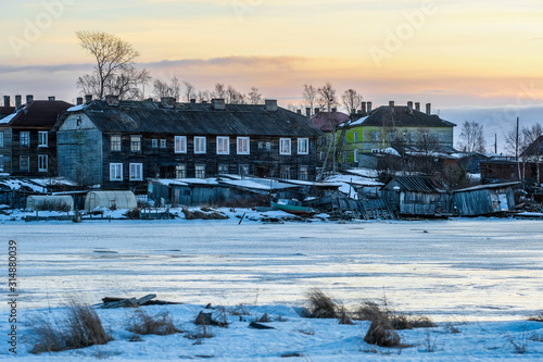 House on a bank of White sea in Rabocheostrovsky, Karelia, Russia, in winter at sunset. photo